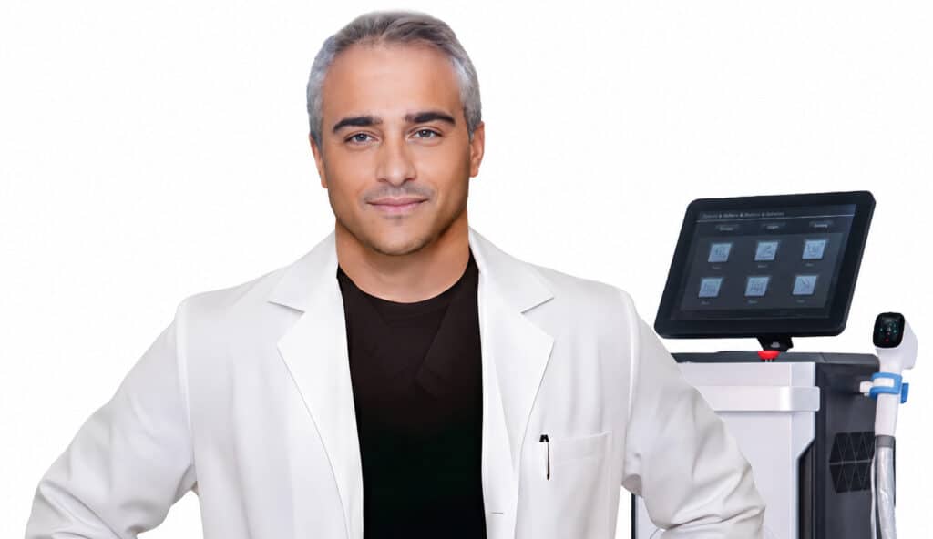 Doctor Leo Capobianco, AML Laser Academy medical instructor, standing beside aesthetic laser equipment in a professional clinical training setting